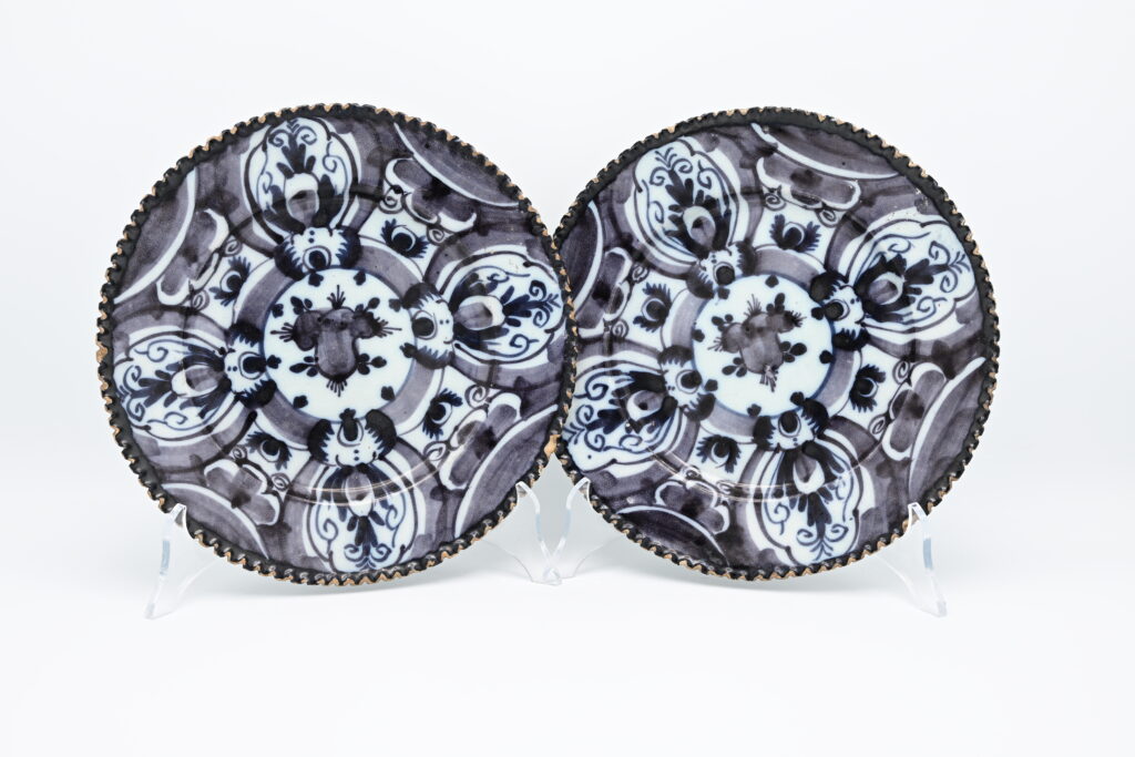 Pair of soft manganese Delftware plates. late 18th century