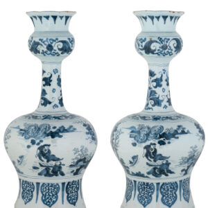 Pair of Blue and White Dutch Delftware Garlic-Neck Vases A pair of octagonal blue and white Dutch Delftware garlic-neck vases, each with a bulbous body supported on a spreading foot and a tall, slender neck with a pronounced knop beneath the flaring trumpet-shaped mouth. The vases are painted in the Transitional style with continuous narrative scenes of Chinese figures in a landscape with trees, rocks and vegetation. This type of decoration was inspired by Chinese porcelain produced during the transitional period between the Ming and Qing dynasties. Delft potters adapted these porcelain designs to the larger, strongly articulated forms of Dutch faience. Delft, circa 1670. Height: 36 cm.